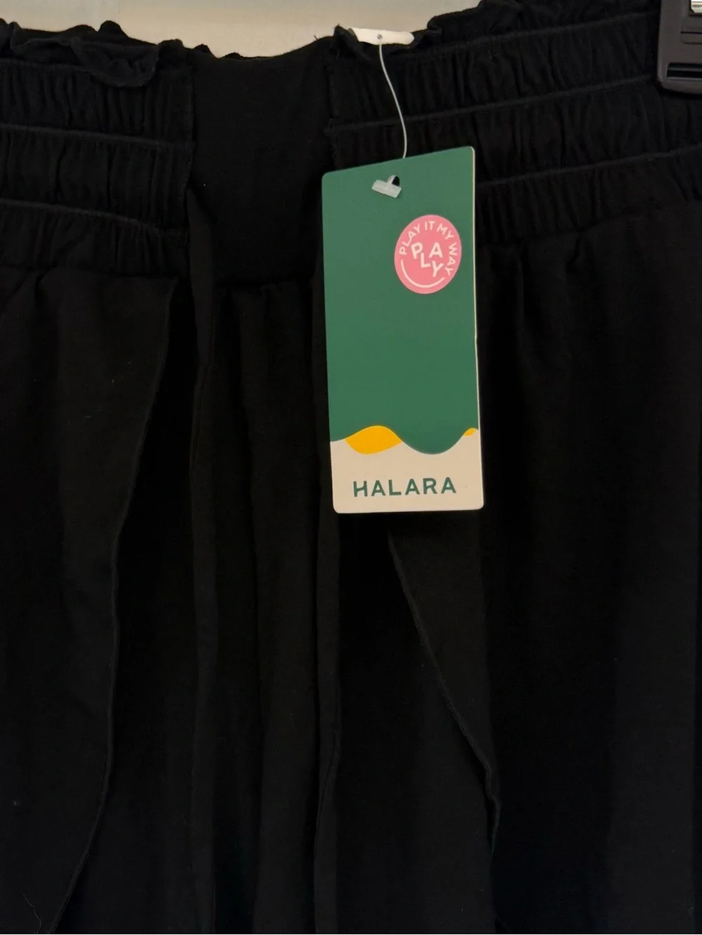 New Halara stretchy black shorts with tie at waist and flowy panels on the front
